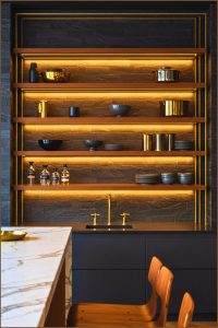 Modern Kitchen Dark Stone Tiles Gold Accented Shelving