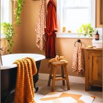Cozy Autumn Inspired Bathroom With A Black Clawfoot Tub