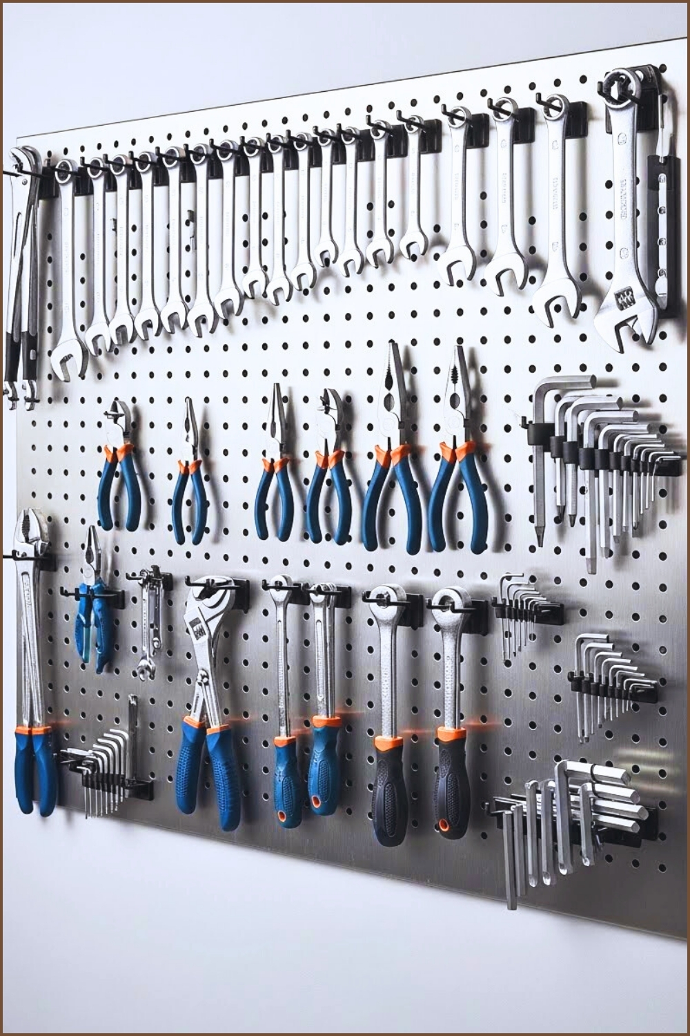 A Clean Garage Wall With Metal Pegboard Holding Wrenches