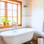 A Cozy Rustic Farmhouse Bathroom Featuring A Freestanding