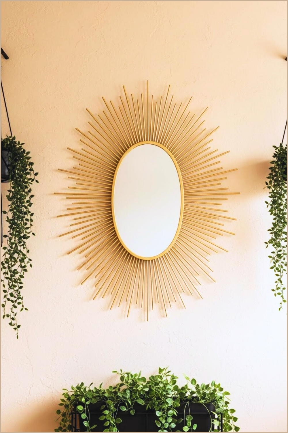 A Warm Boho Interior Wall Featuring A Large Oval Sunburst Mirror